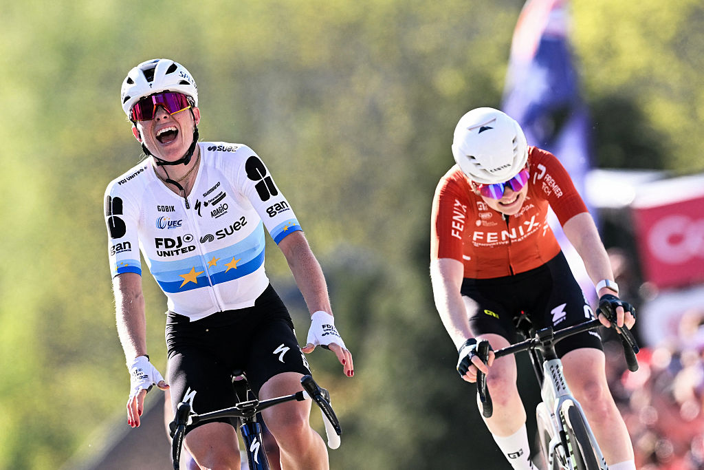 FDJ United - Suez's Dutch Demi Vollering celebrates as she crosses the finish line next to Fenix-Premier Tech's Dutch Puck Pieterse to win 'La Fleche Wallonne'