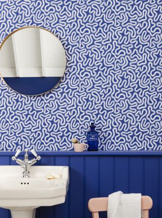 bathroom with bright blue wallpaper