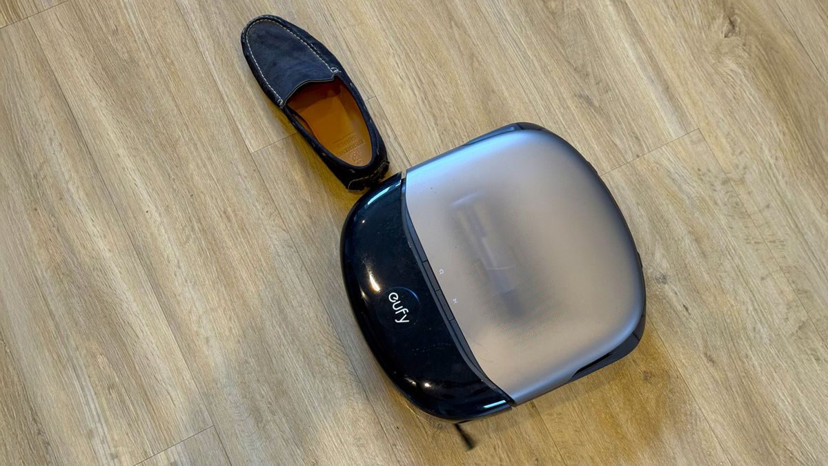 Eufy Omni S2 robot vacuum navigating around a shoe