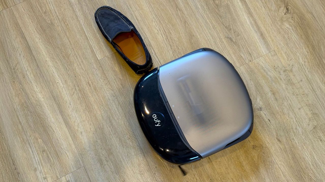Eufy Omni S2 robot vacuum navigating around a shoe