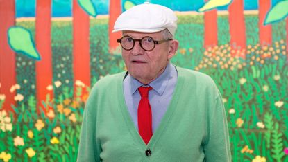 David Hockney poses in front of his painting 'The Arrival Of Spring' in 2017 
