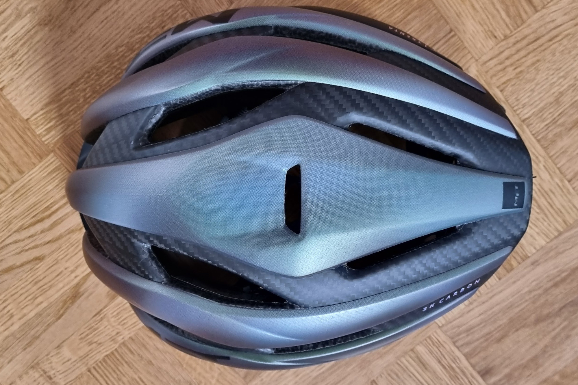 The top of a Met Trenta 3k Carbon helmet shows the carbon weave and ventilation
