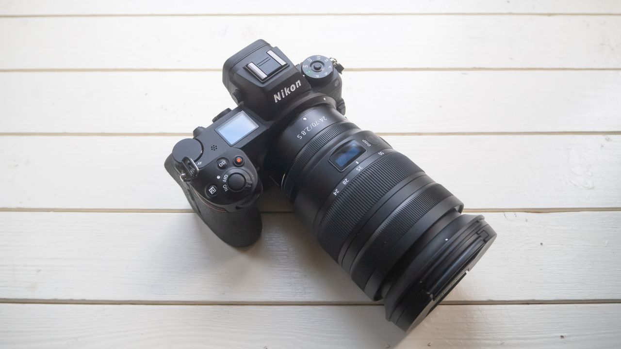 A birds-eye view of the Nikon Z6 II with a lens on a white table.