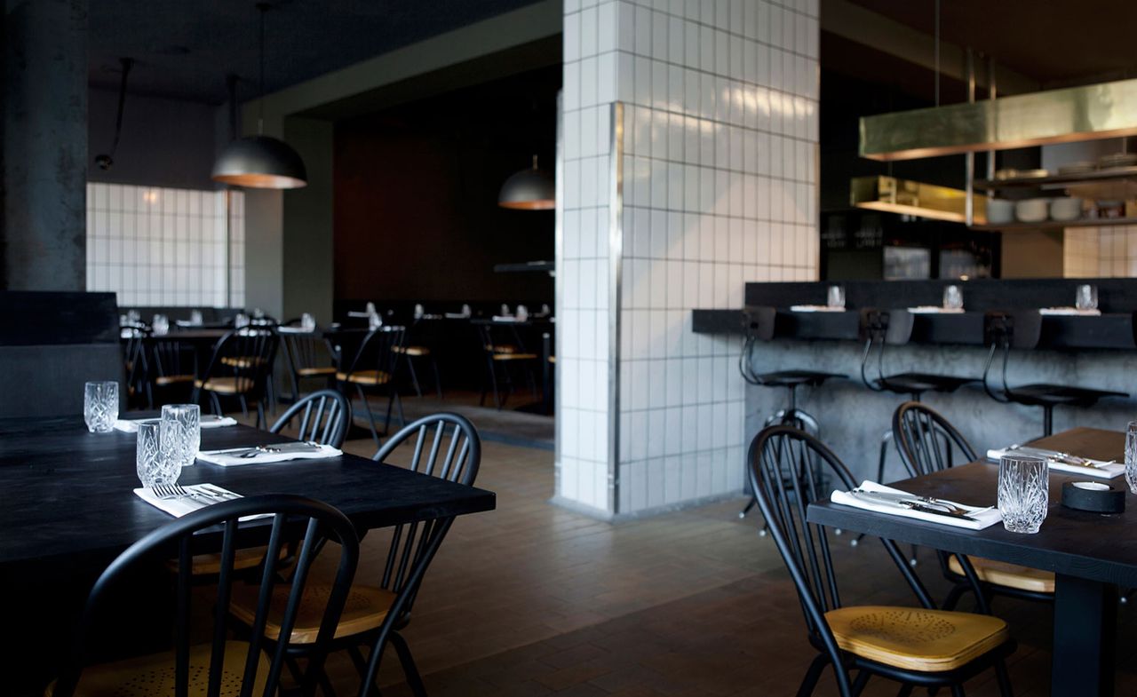 Restaurant with grey walls and dark furniture