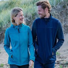 Man and woman modelling Tog24 outerwear on a beach