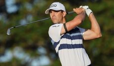 Horschel strikes his iron shot and watches the flight of it