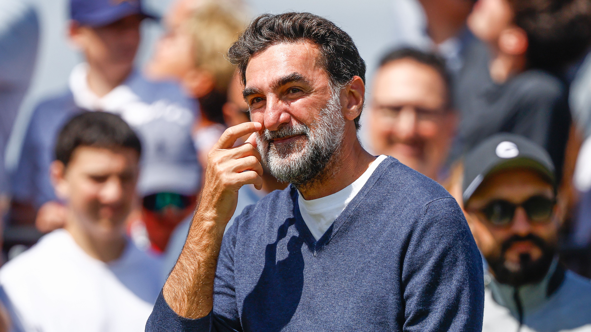 Yasir Al-Rumayyan scratches his cheek during the LIV Golf Team Championship 2025