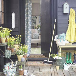 house with grey wooden door and wall and wooden flooring