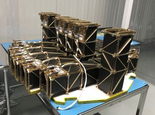 The 10 CubeSats of NASA's ElaNa-19 mission undergo a fit check on the payload plate for Rocket Lab's Electron booster ahead of a launch scheduled for December 2018.