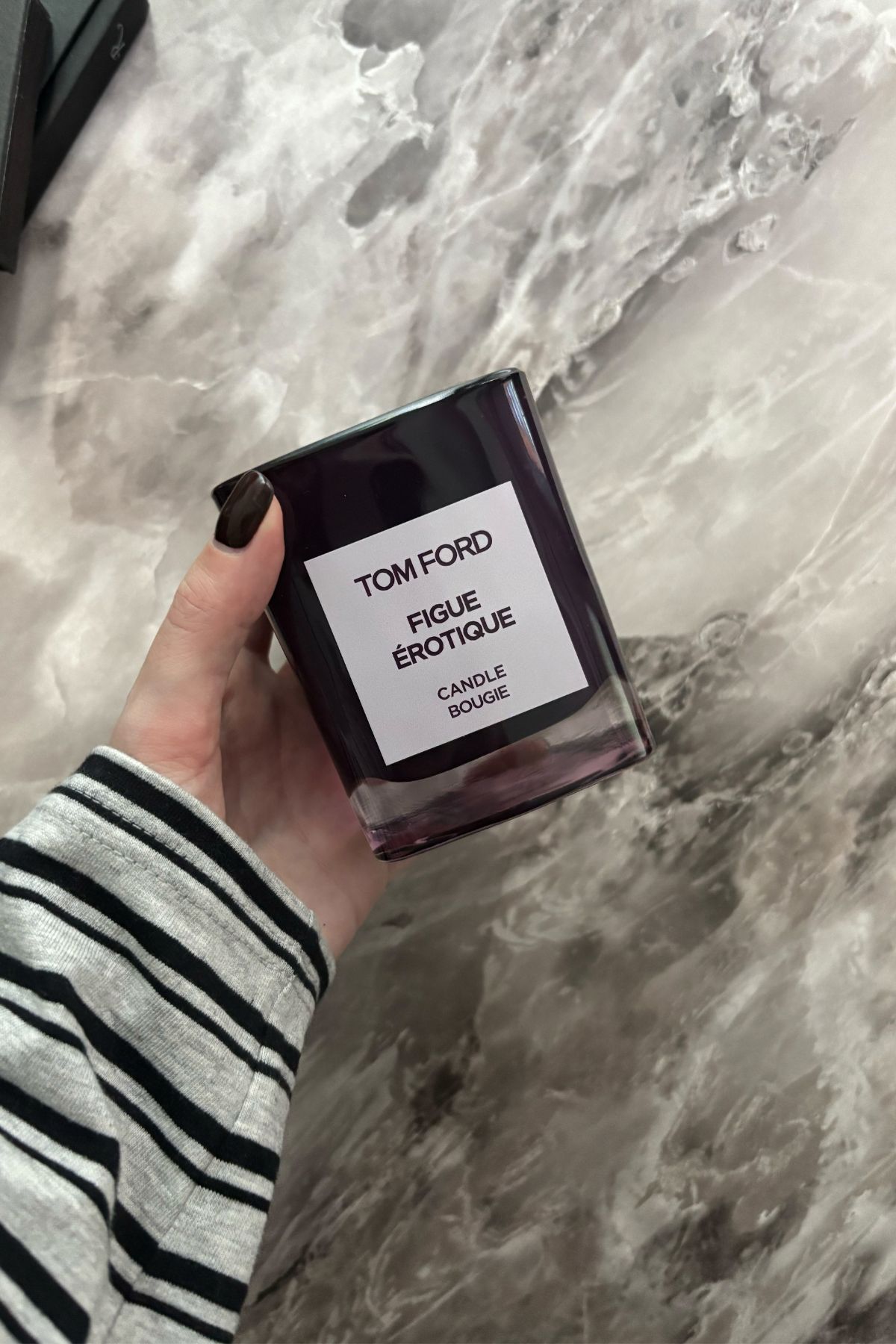 Deputy beauty editor Grace Lindsay holding the Tom Ford Figue &amp;Eacute;rotique candle