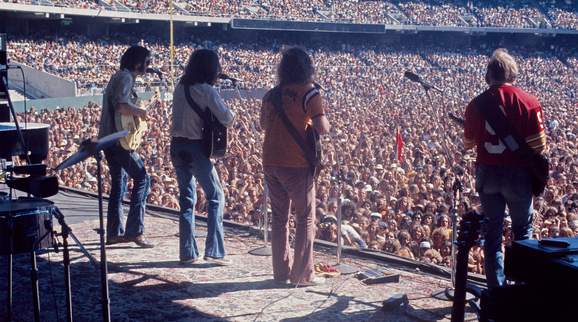 (L-R) Neil Young, Graham Nash, David Crosby and Stephen Stills of Crosby Stills Nash And Young perform on stage at Oakland Colisseum on 13th July 1974 in Oakland, California, United States.