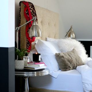 bedroom with white wall and white cushions on bed