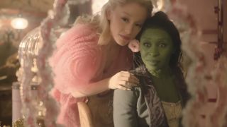 Glinda puts a pink flower in Elphaba's hair in Wciekd