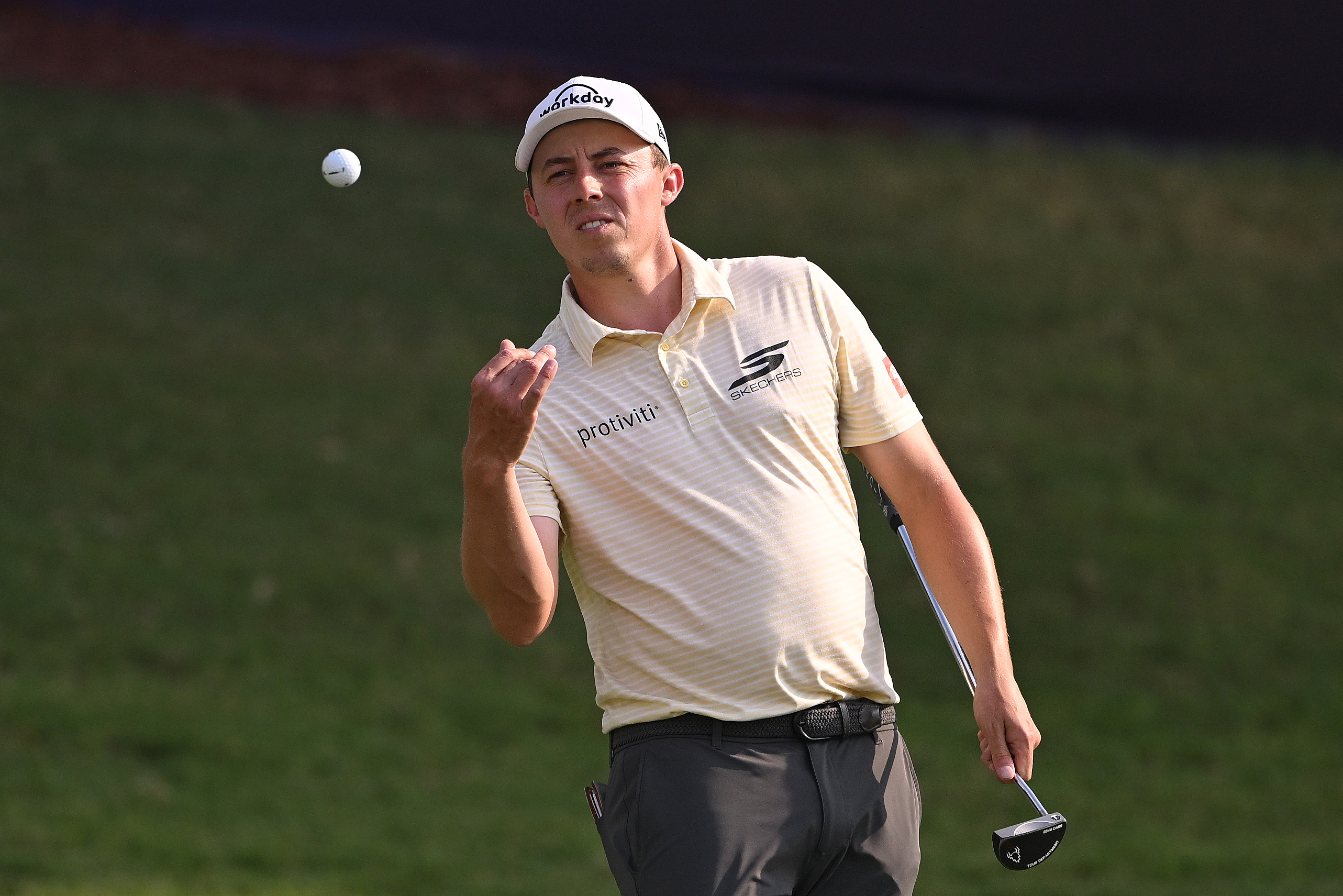 Matt Fitzpatrick throws a golf ball
