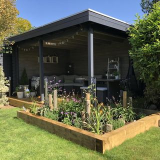 garden decking with roof top area sofa set and plants