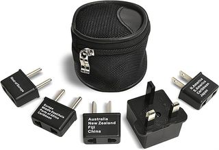 Five black travel adapter plugs around a black mesh carrying case