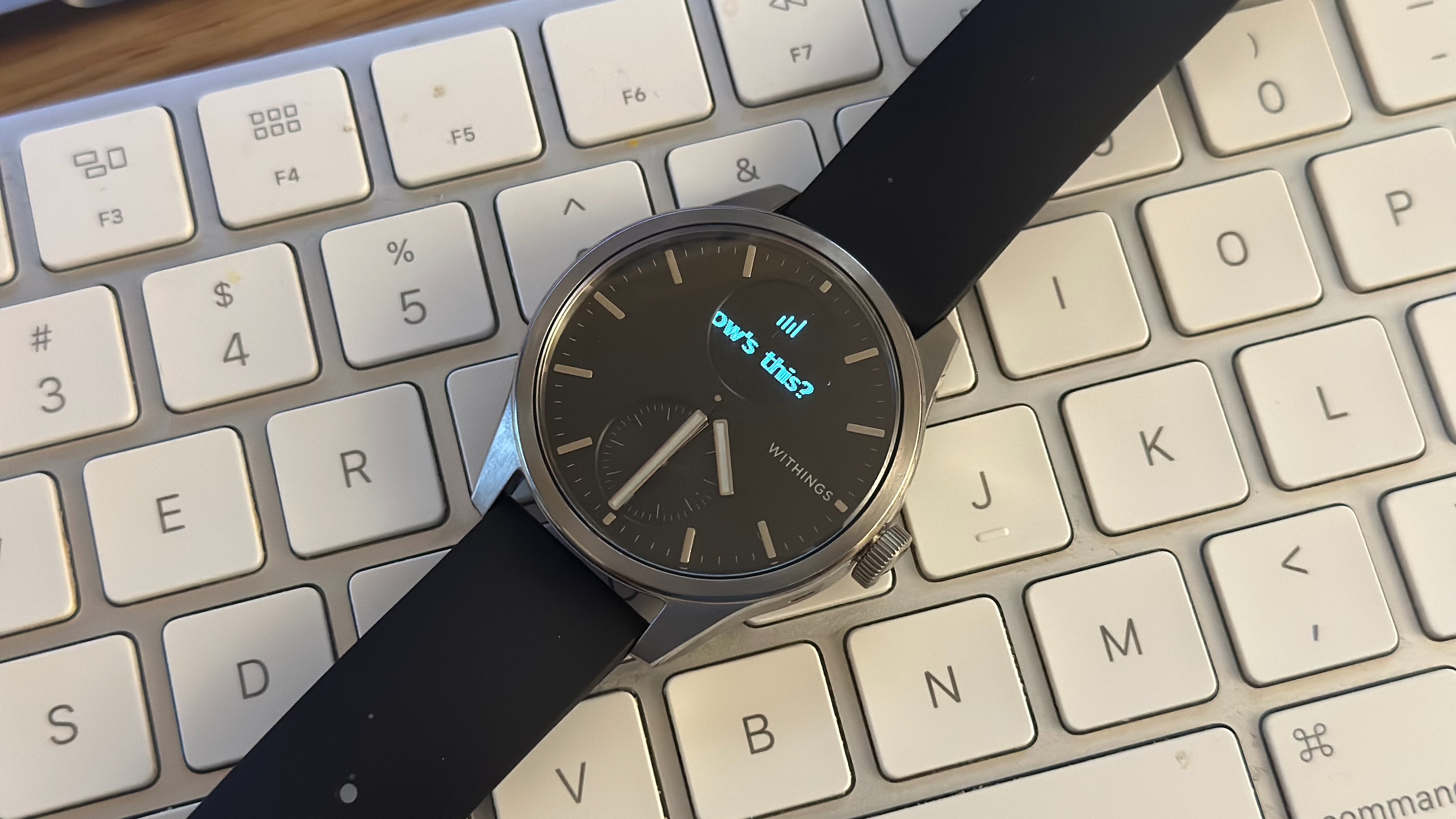 The Withings ScanWatch 2 showing a fraction of a Slack notification, "How's this?"