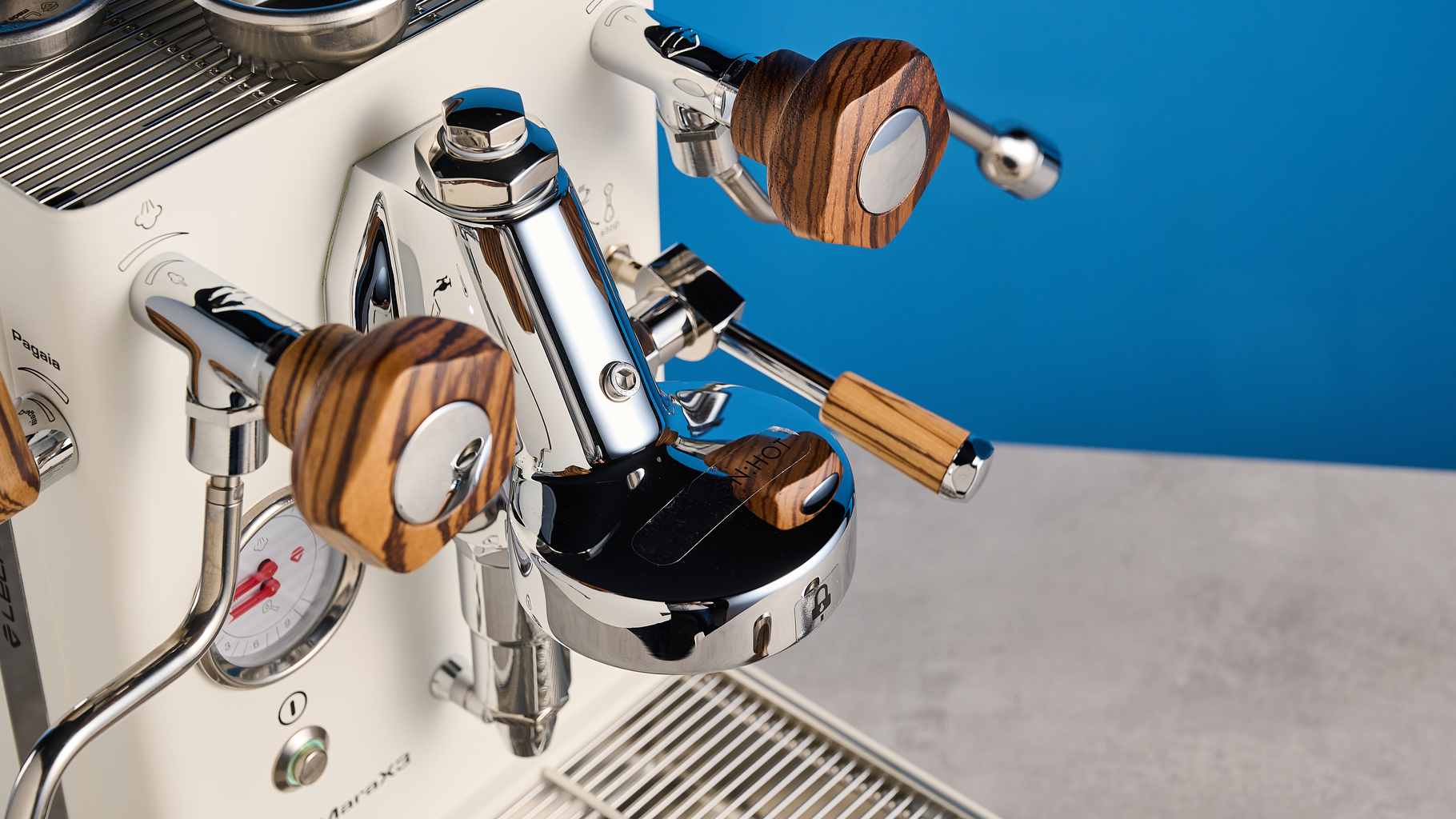the lelit mara x3 in white and walnut photographed against a blue tom's guide background