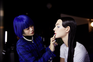 Valentina Li applies chanel lipstick to a model with her finger
