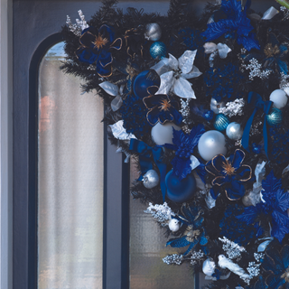 Blue door with blue white and silver Christmas decoration