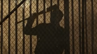Negan banging on the gate in The Walking Dead.
