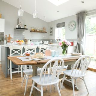 Kitchen dining area with matching taupe curtains and blinds