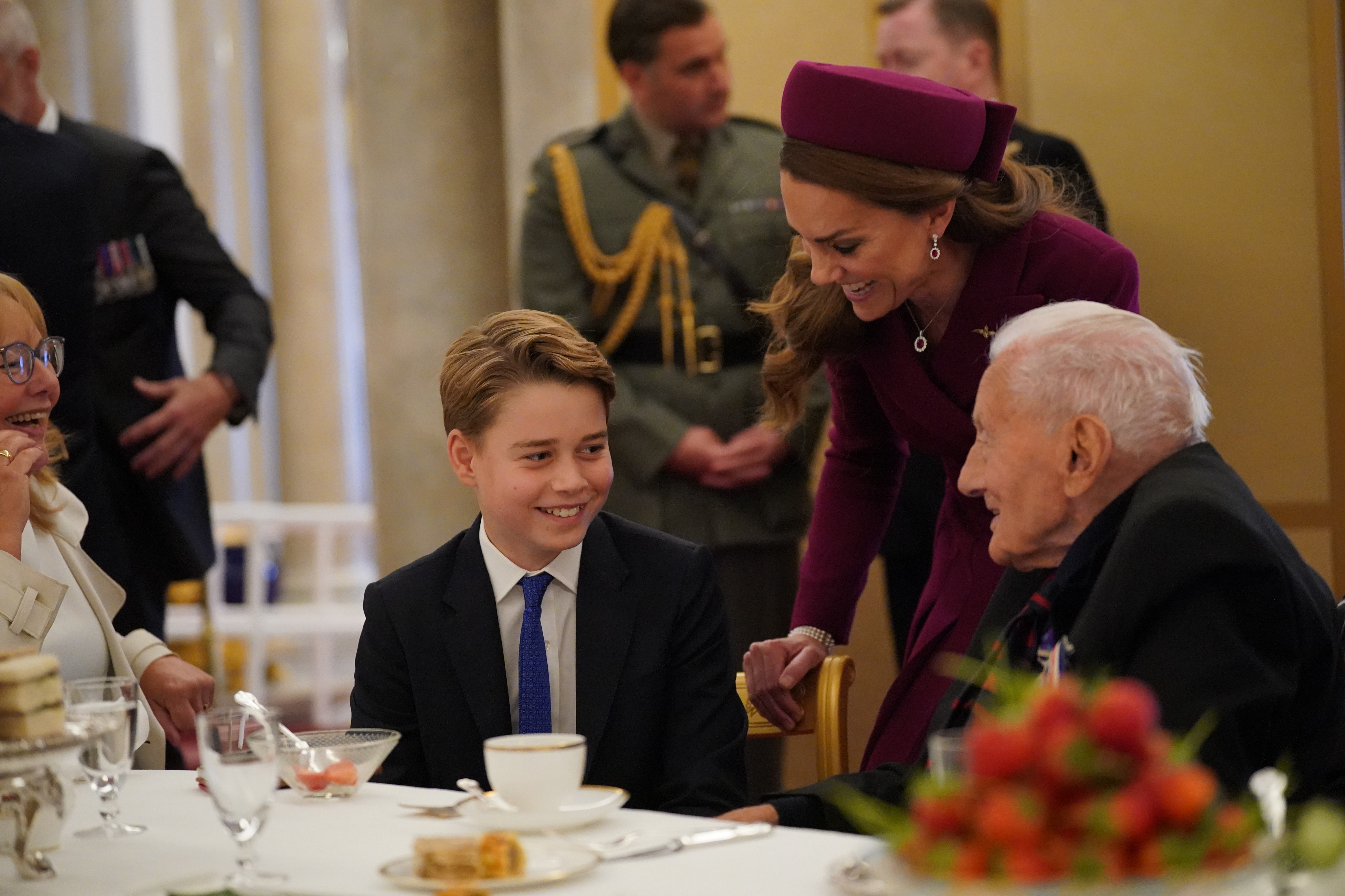 Prince George and Princess Kate speaking with a WWII veteran