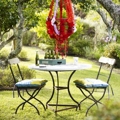 bistro table and chairs in a garden