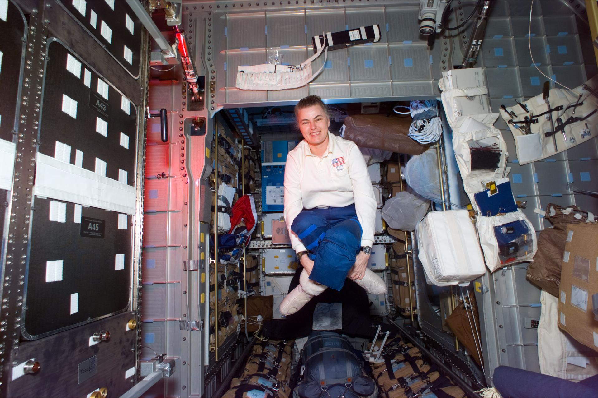 a woman floats in a space station