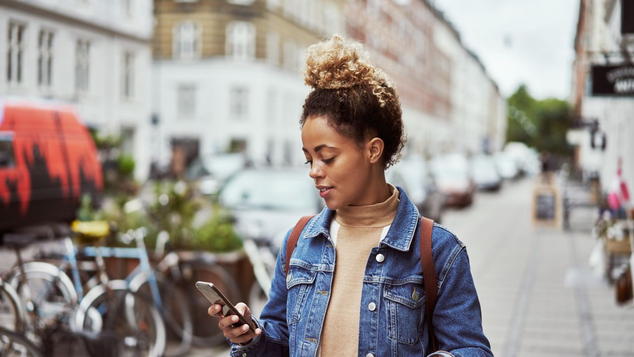 A person using their phone to navigate the city