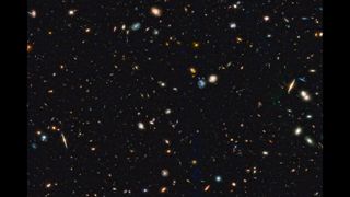 An image showing hundreds of galaxies in deep space.