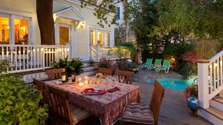 Backyard lighting ideas: image of dinner settings outside near pool