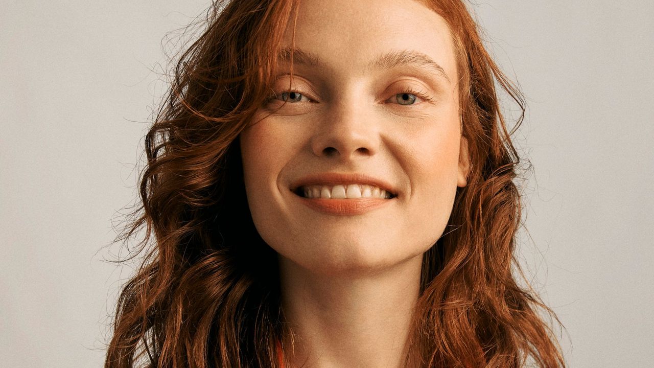 A model with red hair wearing Lancome Labsolu Rouge Lipstick