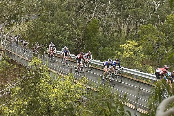 Riders cross a bridge on the 47.7 kilometre circuit around Anakie during stage three of the tour.
