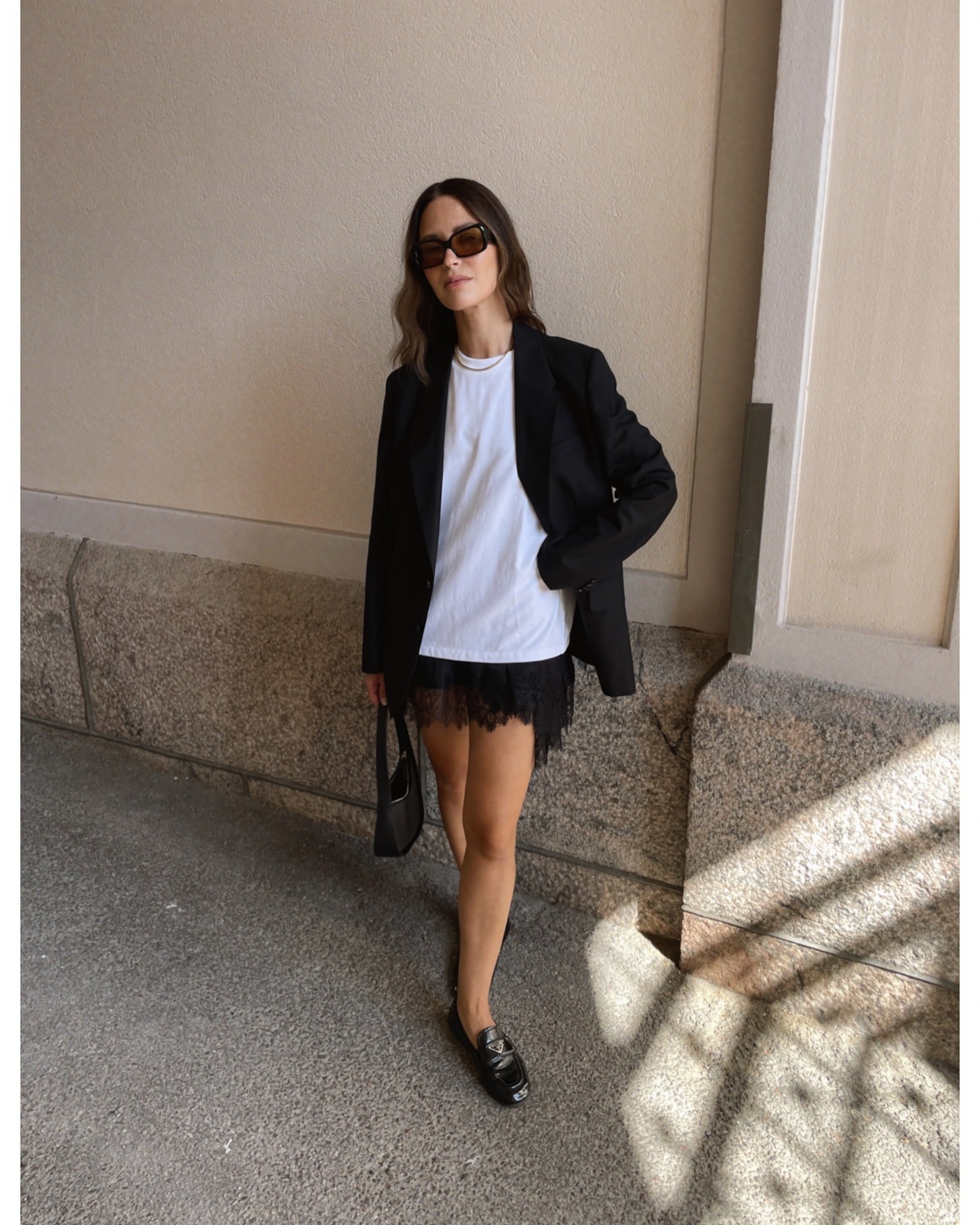 Influencer wearing chic, minimalist black and white outfit.