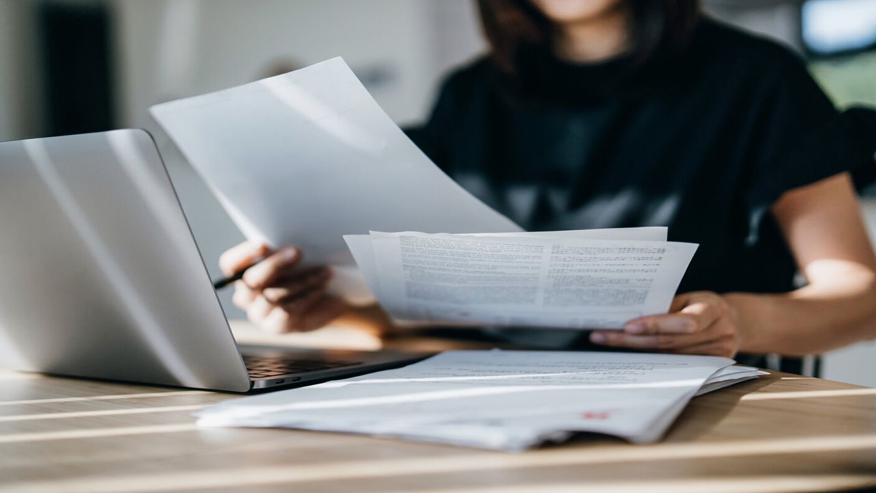 woman looking at bills