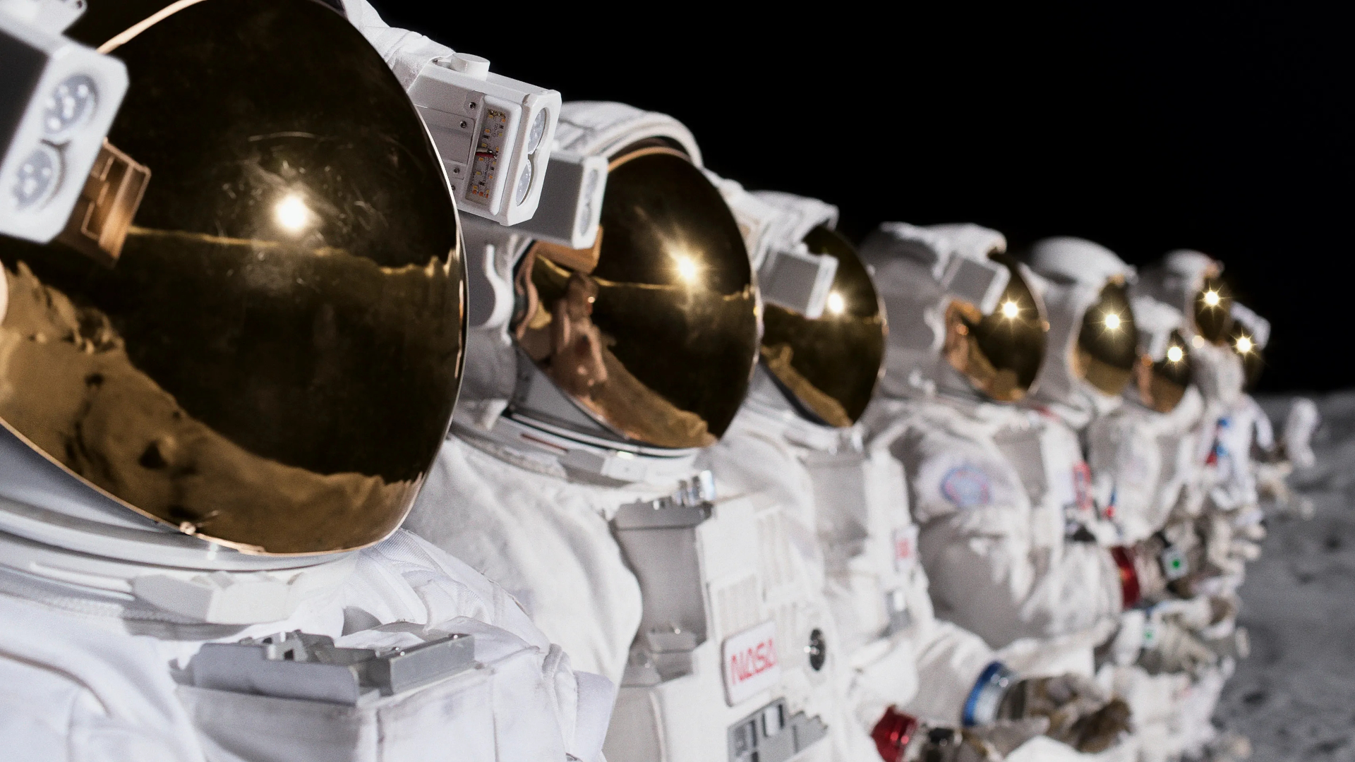 Screenshot from For All Mankind, showing a row of astronauts on the moon.
