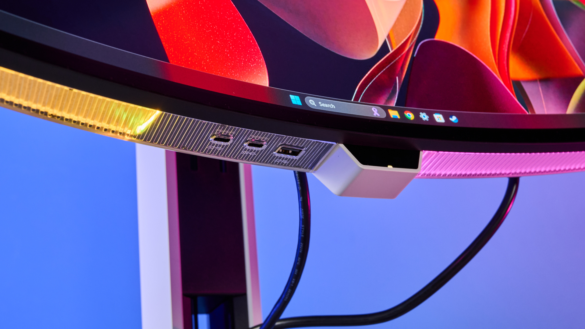 The Lenovo Legion Pro 34WD-10 gaming monitor tilted upwards showing its underneath RGB lighting and front ports