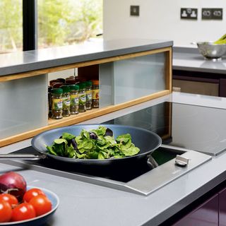 kitchen room with vegetables and induction hob