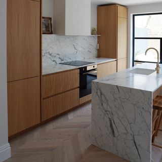 modern kitchen with island breakfast bar and marble worktops
