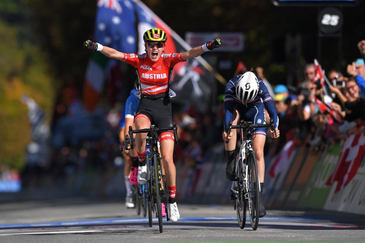 Laura Stigger raises her arms in celebration