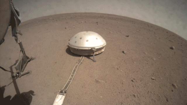 The fisheye Instrument Context Camera under the NASA Insight lander's deck caught this view of its robotic arm moving the support structure for the "mole" digging instrument as it was slowly removed from the Martian ground.