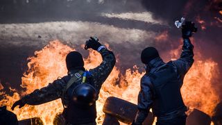 Anti-government demonstrators clash with riot police in central Kiev on February 18, 2014. Opposition leader Vitali Klitschko on February 18 urged women and children to leave the opposition's