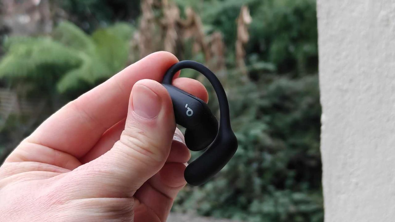 The Soundcore Aerofit 2 Pro in a man's hand, in open mode.