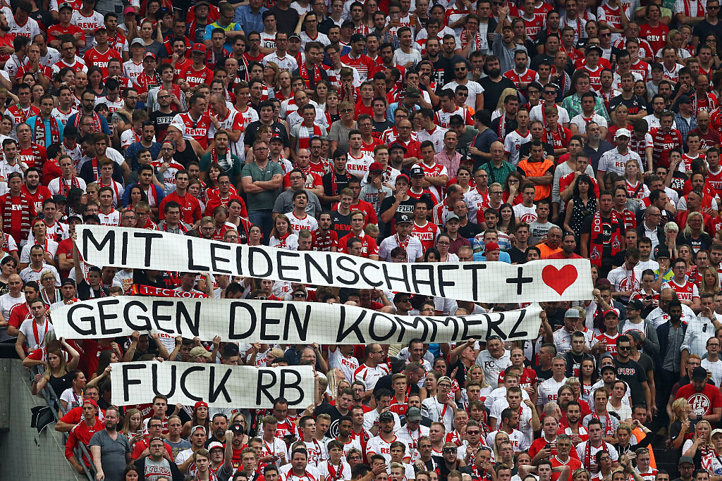 Fans of Koeln hold up a sign saying ' Mit Leidenschaft + Liebe genen den kommerz fuck RB Leipzig' or 'With Passion + love against the commercialism fuck RB Leipzig' in English during the Bundesliga match between 1. FC Koeln and RB Leipzig at RheinEnergieStadion on September 25, 2016 in Cologne, Germany.