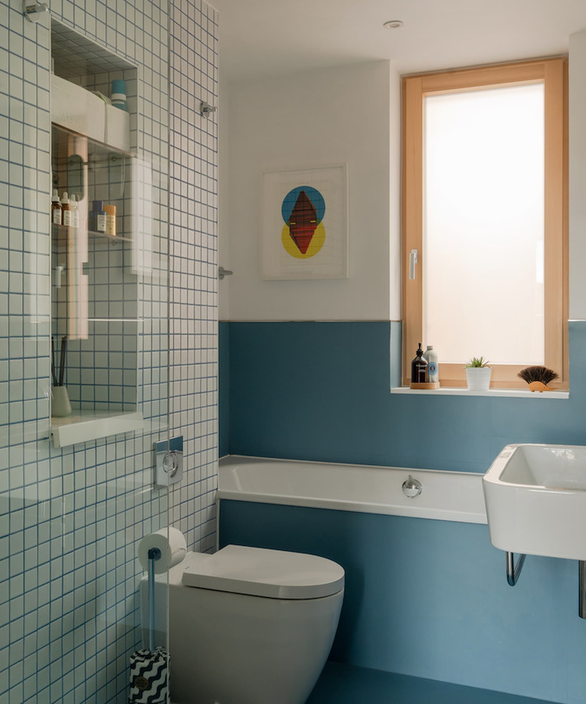 A blue bathroom with a blue bath and a walk-in shower