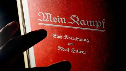 (FILES) - Picture taken on June 14, 2005 shows a man reading a signed copy of a first edition of Adolf Hitler's book Mein Kampf at Bloomsbury Auction House.Authorities in the southern German 