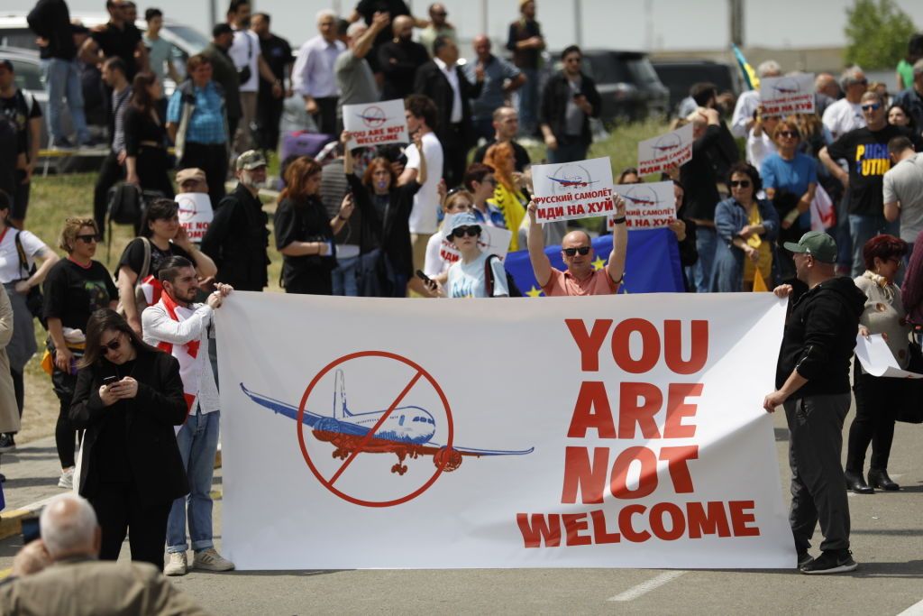 Georgians protest the arrival of a Russian plane. 