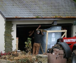 biomass boiler being delivered into garage