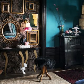 blue wall with dressing table with mirror and lamp